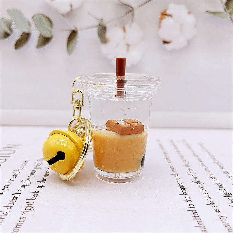 Comercio al por mayor acrílico flotando en el aceite de chocolate arenas movedizas llavero creativo